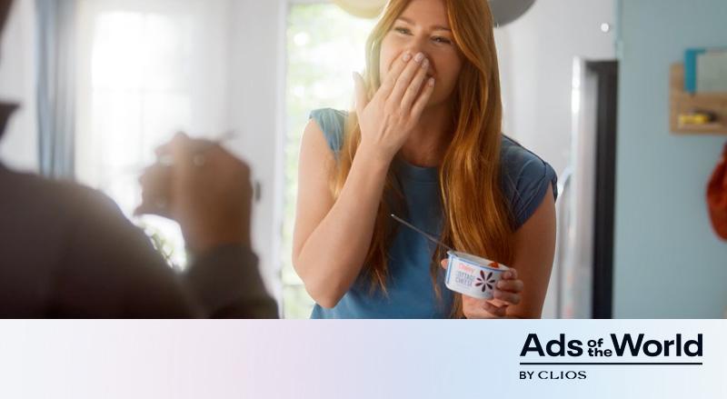 Woman enjoying Daisy Cottage Cheese in kitchen