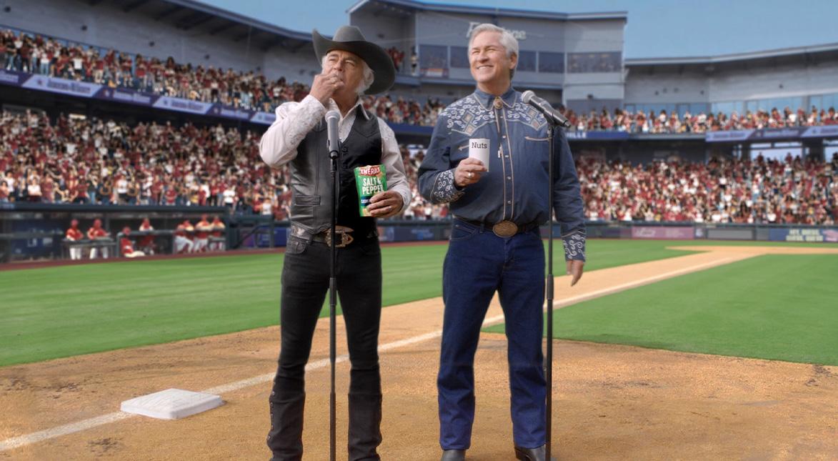 2 men singing in a baseball stadium. 